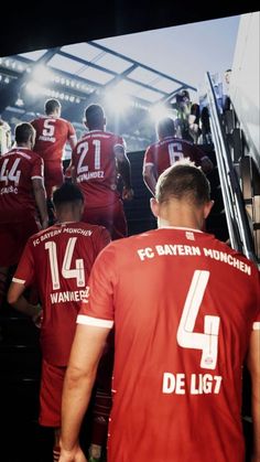several soccer players are walking up the stairs