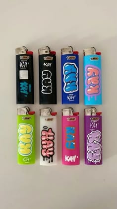 six lighters with different designs on them