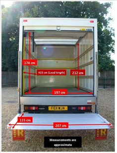 the back end of a truck with its doors open and measurements in red on it