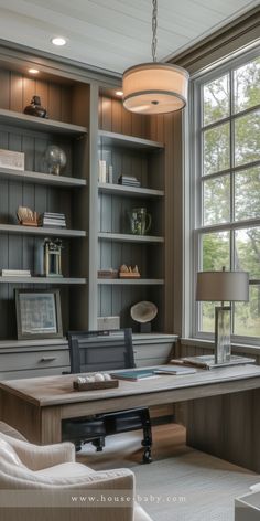 a home office with built - in bookcases and desk