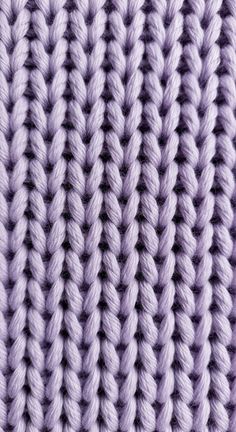 close up view of the crochet stitchs on a knitted blanket in purple