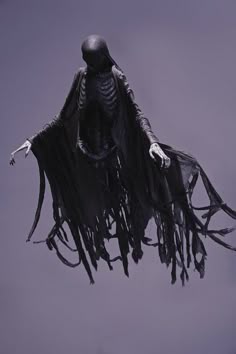 a skeleton dressed in black flying through the air