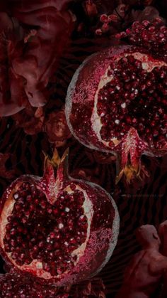 two pomegranates in the shape of a heart on a black background