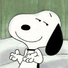 a cartoon character with a black and white dog on his chest, standing in front of a green curtain