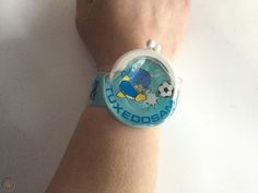 a person's wrist with a cartoon watch on it
