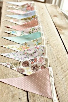 a row of fabric buntings sitting on top of a wooden table