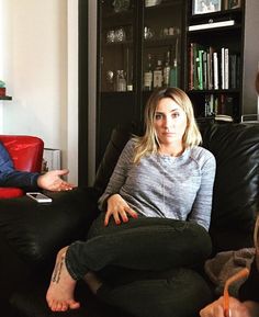 two women sitting on a couch talking to each other