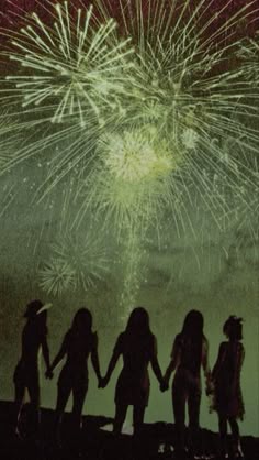 silhouettes of people holding hands with fireworks in the background