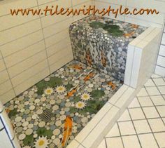 two boxes with flowers on them are in the corner of a tiled room, one is empty