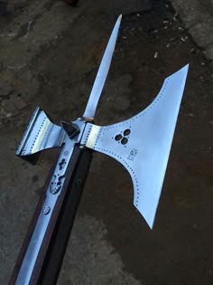 a close up of a metal object with a bow on it's end and two knives sticking out of it