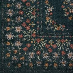 an area rug with many different colors and designs on the carpet, including flowers in various sizes