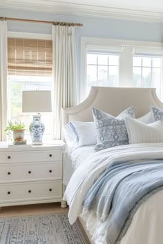 a bedroom with blue and white decor in it