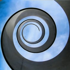 an abstract spiral design with blue sky in the background