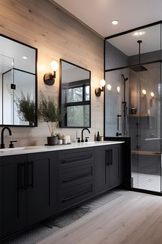 a large bathroom with two sinks, mirrors and a walk - in shower next to a wooden floor