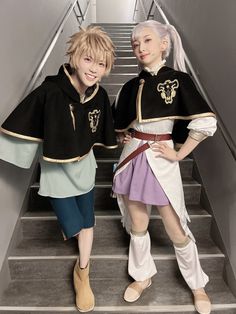 two women in costumes standing on the stairs