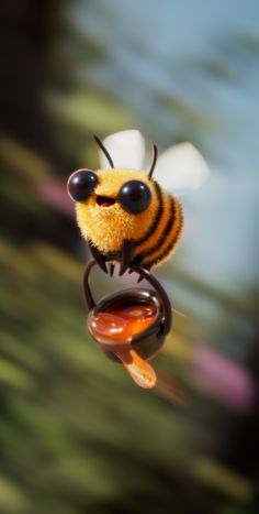 a close up of a toy bee flying in the air with it's eyes open