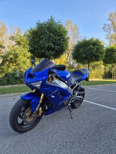 a blue motorcycle parked in a parking lot