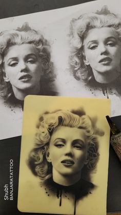 a black and white photo of marilyn monroe's face next to a fountain pen