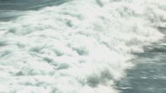 a man riding a wave on top of a surfboard