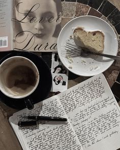 a piece of cake on a plate next to a cup of coffee and a book