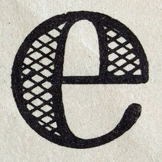 the letter e is made out of black wire and has an oval design on it