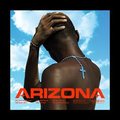 the back of a man's body with a cross on his neck and hands over his head