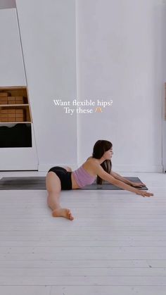 a woman is laying on the floor with her back to the camera and looking up