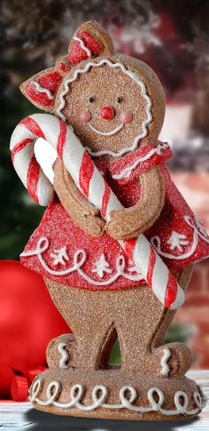 a gingerbread man holding a candy cane