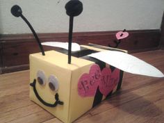 a cardboard box that has been made to look like a bee with wings and eyes