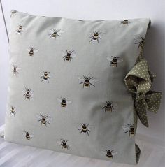 a pillow with a bow on it sitting next to a wall