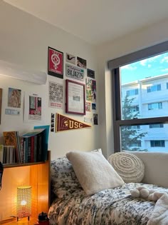 a bedroom with a bed, bookshelf and window in the corner next to it