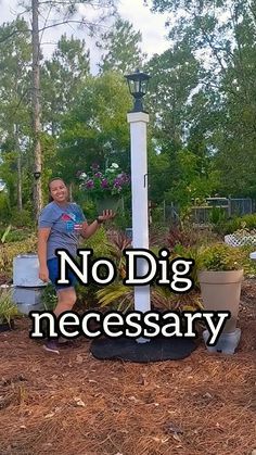 a woman standing next to a light post with plants growing out of it and the words no dig necessary