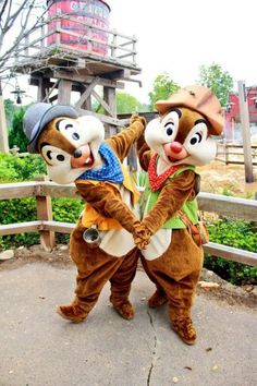 two people dressed as chipmuns standing next to each other