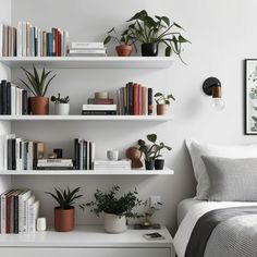a bedroom with white walls and shelves filled with books, plants, and other items