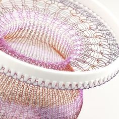 there are two pieces of wire on top of each other in the same pattern as they appear to be woven