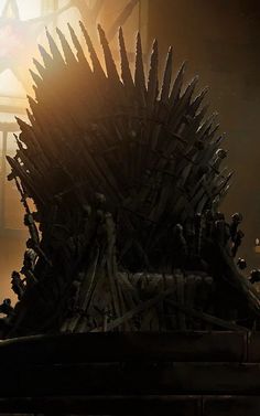 a large iron throne sitting in front of a stained glass window