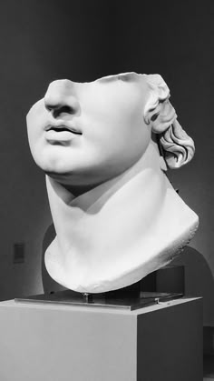 a black and white photo of a sculpture of a man's head