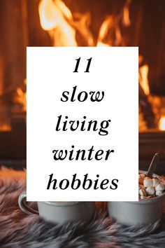 two mugs with marshmallows in front of a fireplace and the words 11 slow living winter hobbies