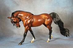 a toy horse is shown on a gray background