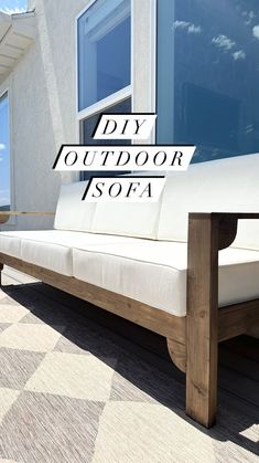 a white couch sitting on top of a wooden floor next to a window with the words diy outdoor sofa
