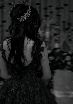 a woman in a brown dress with a tiara on her head and back to the camera