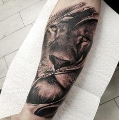 a man with a lion tattoo on his arm