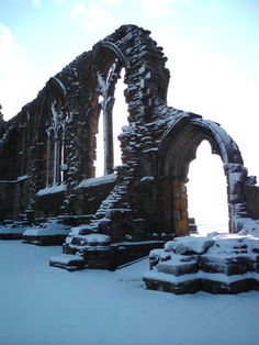 an old building with snow on the ground