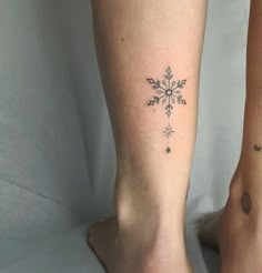 two people with matching tattoos on their legs, one has a snowflake tattoo