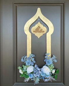 the front door is decorated with blue flowers and an arabic - style sign on it