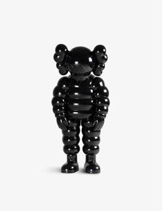 a black balloon bear standing in front of a white background