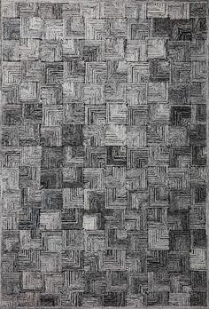 a black and white rug with squares on the bottom, in grey tones that appear to be woven together