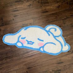 a blue and white rug with an image of a cartoon character laying on the floor