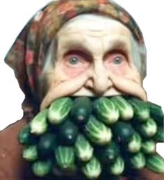 an old man with a bunch of green vegetables in front of his face and nose