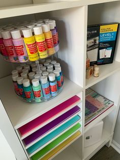 the shelves are filled with many different types of paint and crafting supplies on them